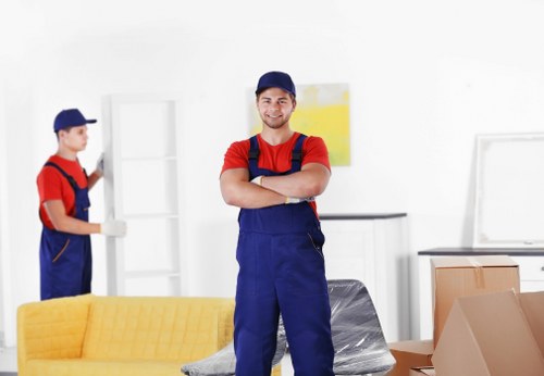 Workers loading boxes safely for a man with a van service
