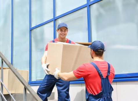 Removalists preparing furniture and boxes for transport